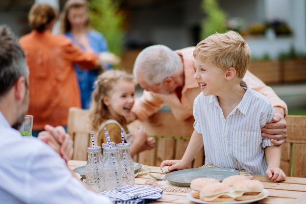 Multi generation family having an outdoor garden party.