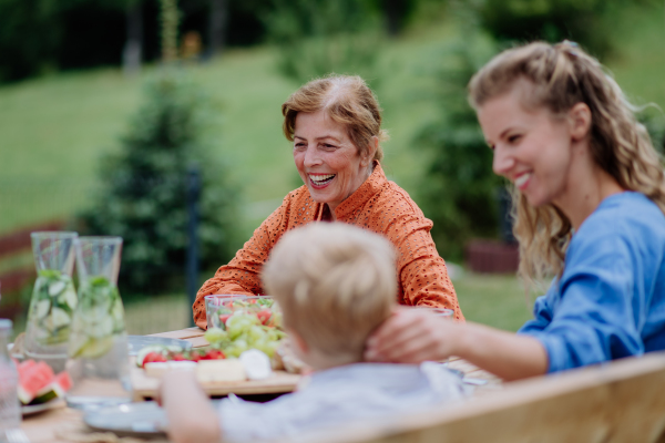 Multi generation family having an outdoor garden party.