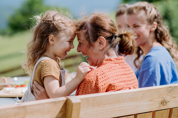 Rear view of a happy family during outdoor garden party.