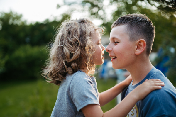 Younger and older brother are touching noses. Sibling love and a lifelong relationship.