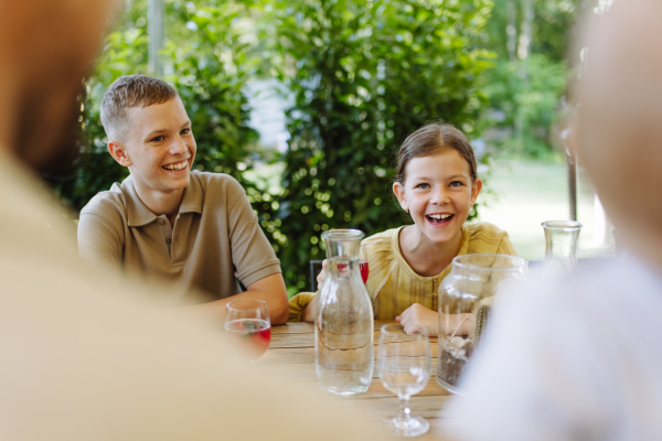 Young children enjoying family time in restaurant. A small family celebration in family friendly restaurant.