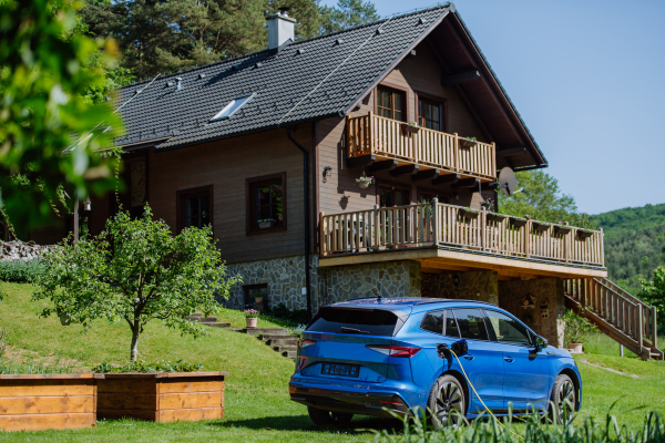 Close up of electric car chaging in family garden.