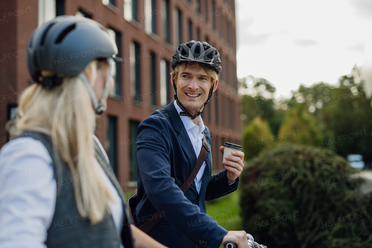 Colleagues, spouses commuting through the city, buying, drinking coffe in front of office. Middle-aged city commuters traveling from work by bike after a long workday.