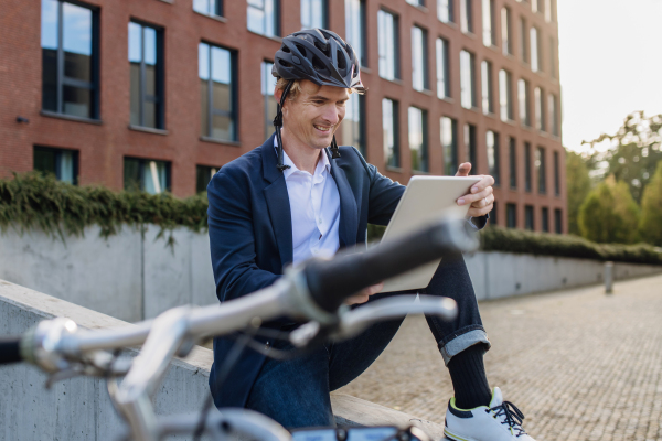 Portrait of businessman, freelancer or manager working outdoors in city park. Man with laptop on knees having video call. Concept of working remotely.