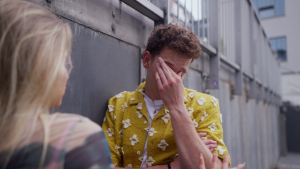 Gen Z couple having an argument outdoors in the city. Modern-day relationship problems among young peope.