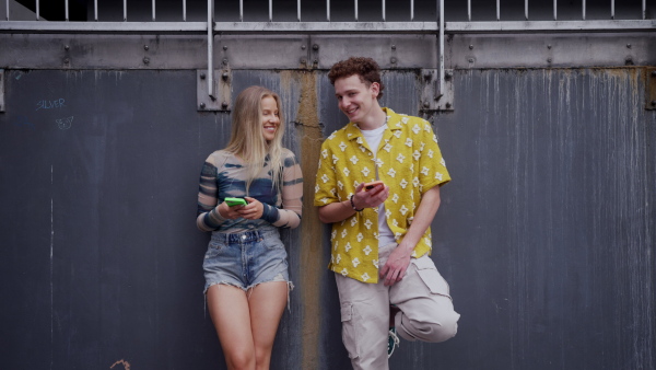 Video of generation z couple spending time outdoors in the city online. Students spending free time online, watching social media content. Concept of gen Z as loneliest generation.