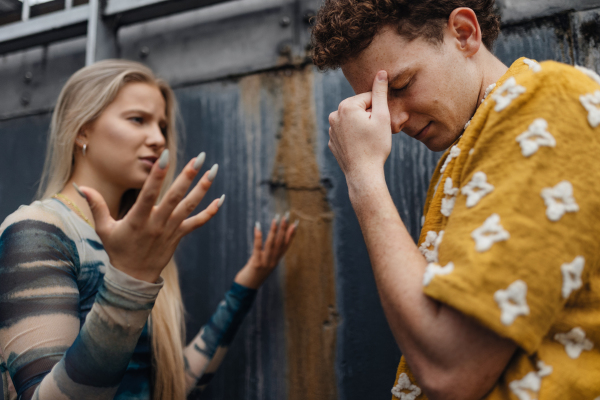 Gen Z couple having an argument outdoors in the city. Modern-day relationship problems among young peope.