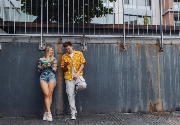 Young stylish generation Z couple spending time outdoors after school. Concept of power of friendship and importance of education for gen Z.