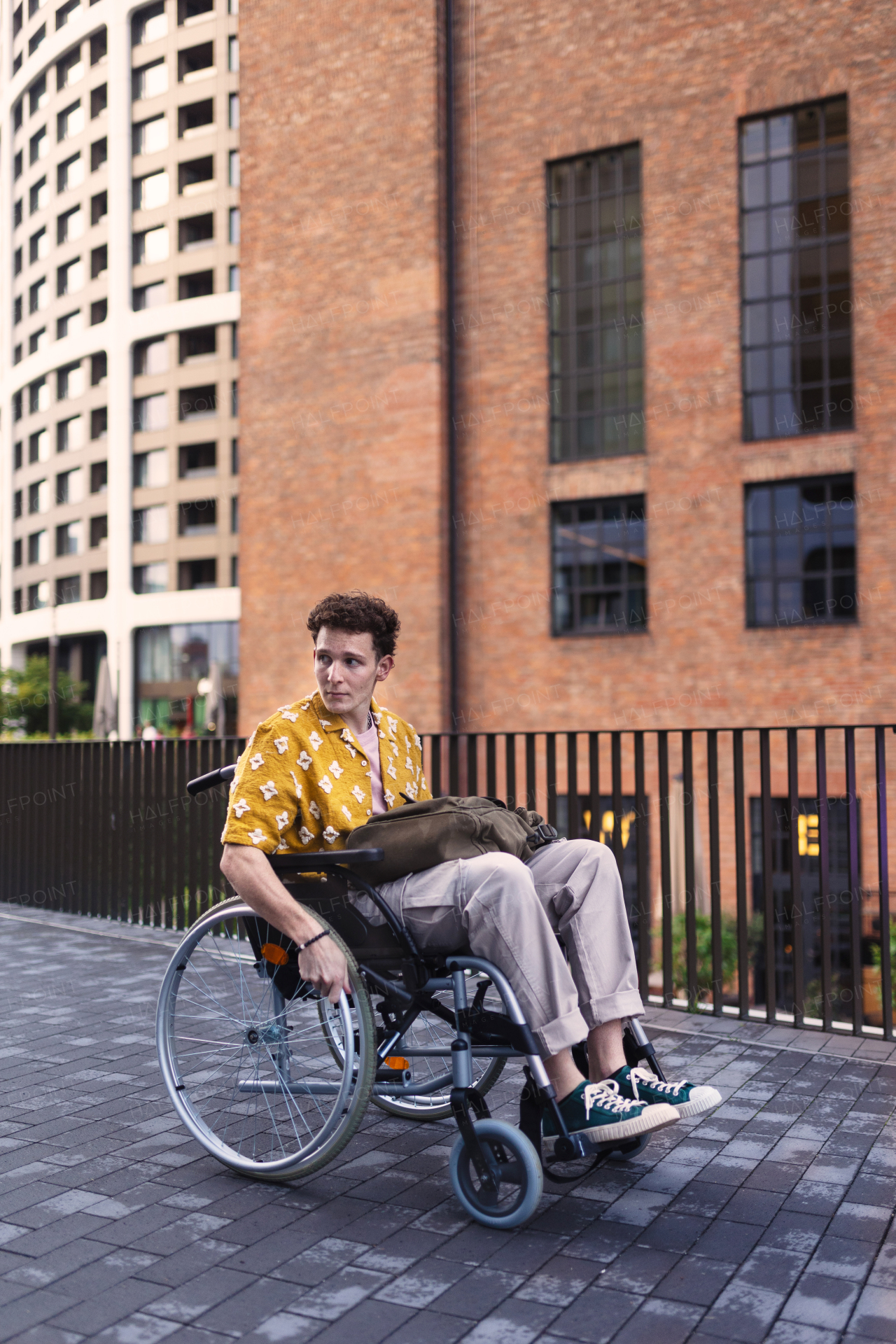 Gen Z boy in a wheelchair in the city. Inclusion, equality, and diversity among Generation Z.