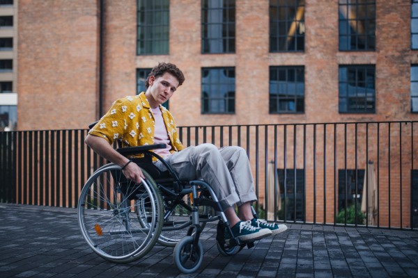 Gen Z boy in a wheelchair in the city. Inclusion, equality, and diversity among Generation Z.