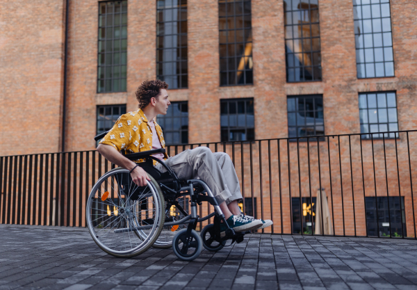 Gen Z boy in a wheelchair in the city. Inclusion, equality, and diversity among Generation Z.