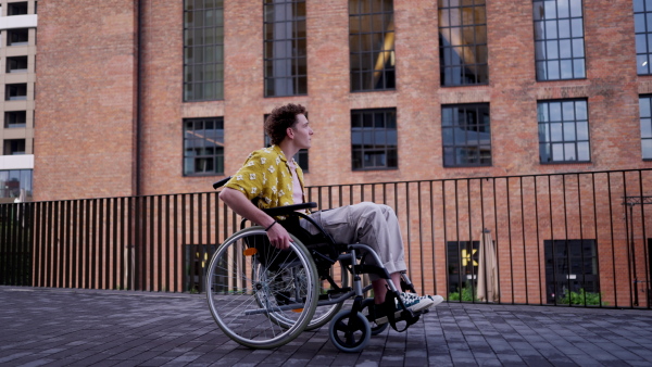 Gen Z boy in a wheelchair in the city. Inclusion, equality, and diversity among Generation Z.