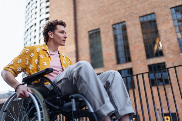 Gen Z boy in a wheelchair in the city. Inclusion, equality, and diversity among Generation Z.