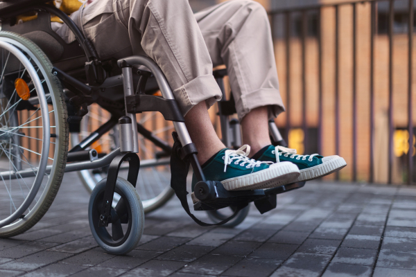 Close up of young gen Z boy in a wheelchair in the city. Inclusion, equality, and diversity among Generation Z.