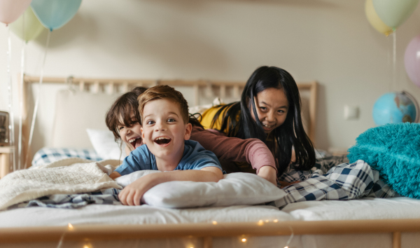 Three happy friends having fun together in room.