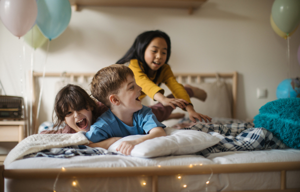 Three happy friends having fun together in room.