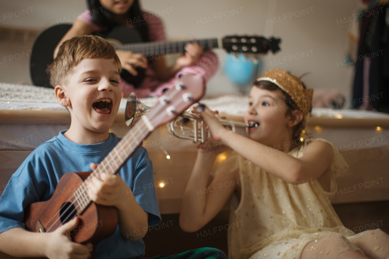 Happy three friends playing on the musical instuments.