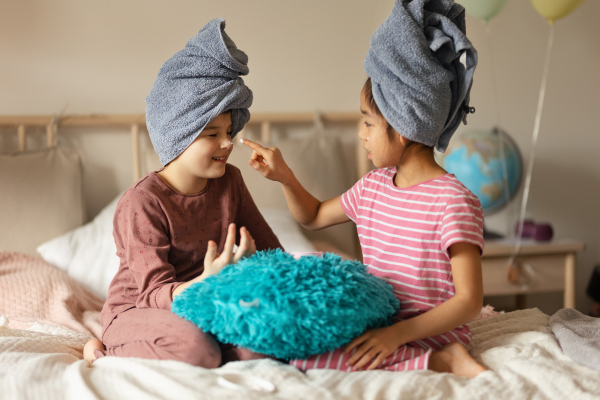 Little girl having fun during a skincare routine.