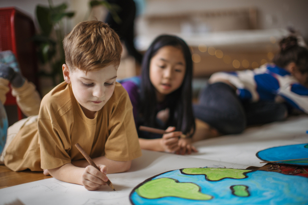 Happy friends drawing together in the room.