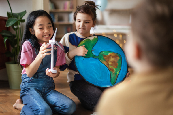 Little children talking about environmental topics in room.