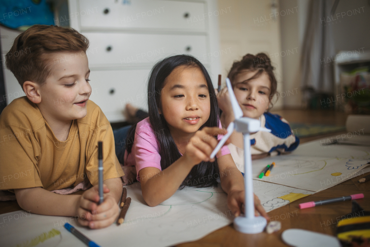 Happy friends drawing together in the room.