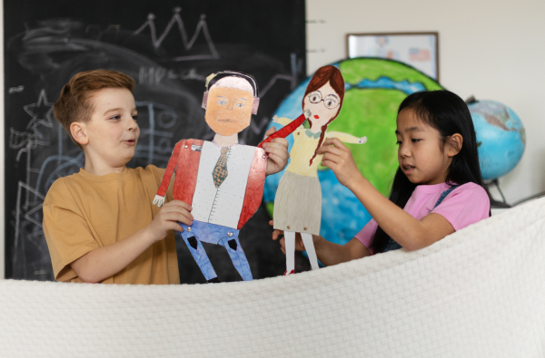 Little children playing with beautiful handmade puppets.