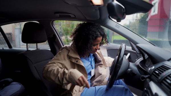 Female nurse going home from work, getting into car. Female doctor driving car to work, on-call duty. Work-life balance of healthcare worker as parent and partner.