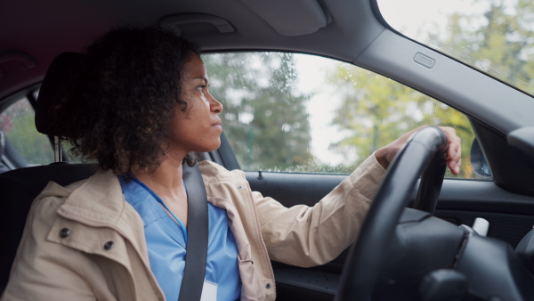 Female nurse going home from work. Female doctor driving car to work, on-call duty. Work-life balance of healthcare worker as parent and partner.