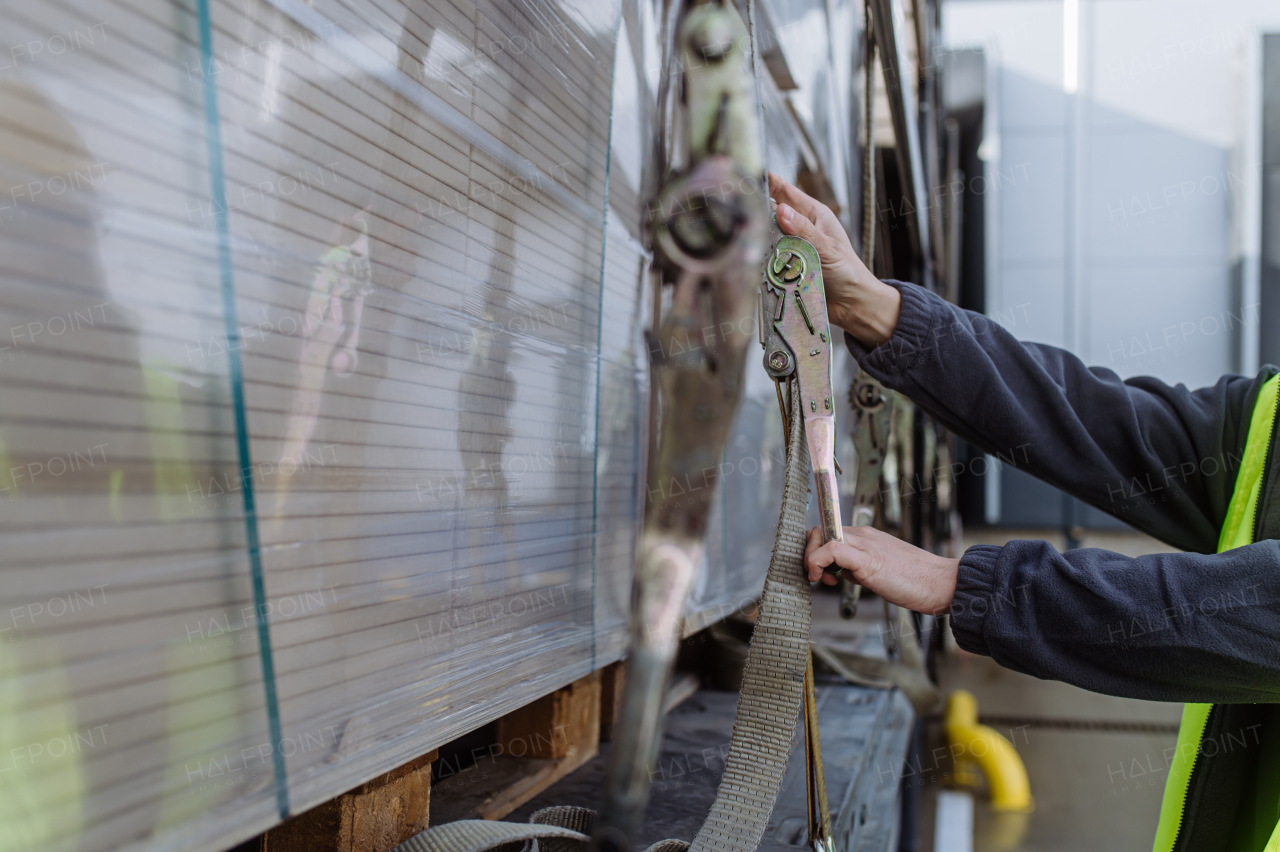 Warehouse receivers unloading of the truck in front of warehouse, checking delivered items. Unloading cargo.