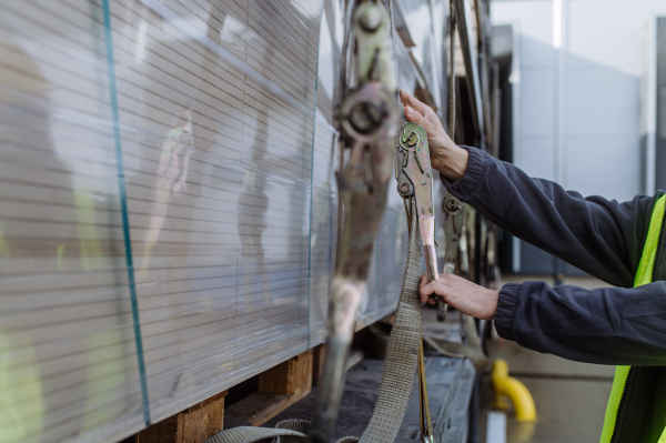 Warehouse receivers unloading of the truck in front of warehouse, checking delivered items. Unloading cargo.