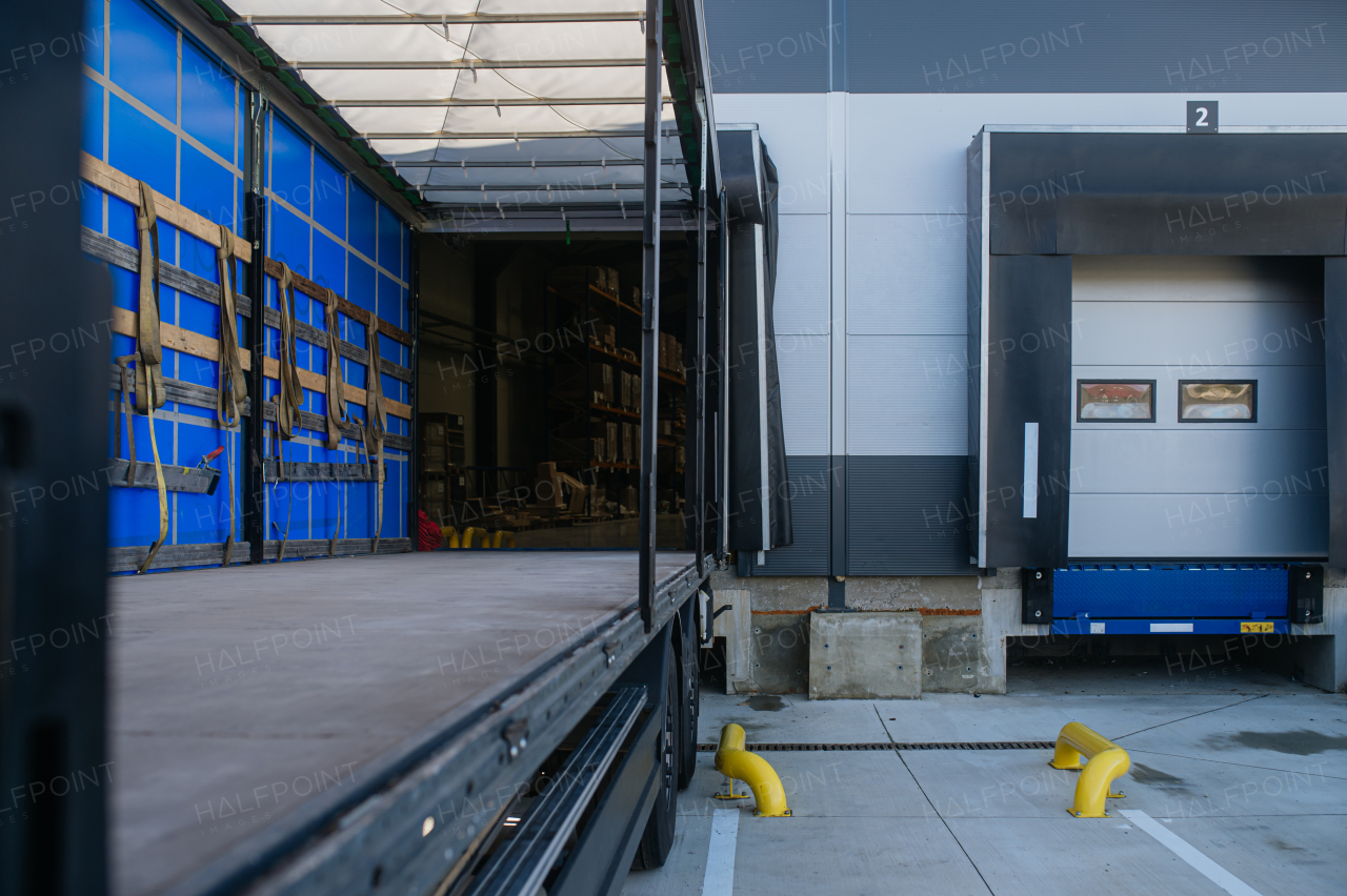 Close up of empty truck parked in warehouse loading dock. Concept of load management.