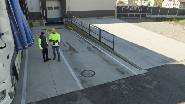 A top view of warehouse receivers unloading of the truck in front of warehouse.