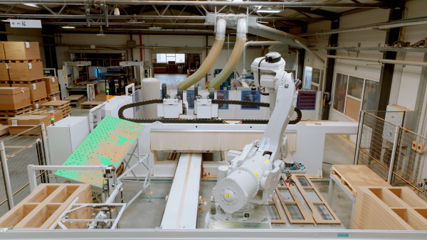 Industrial automation and robotics in modern industrial factory. Advanced, high precision robotic arm assembling wooden furniture in big furniture manufacturing facility with robotic arms and automation.