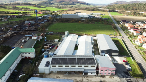 Aerial view of a solar panels on rooftop of factory. Solar energy as renewable energy source in business.