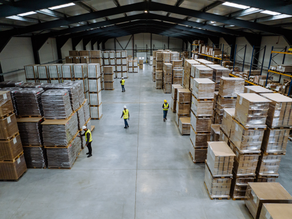 Top aerial view of workers modern warehouse storage of retail shop, large factory workshop space. Employees in modern industrial factory with warehouse.