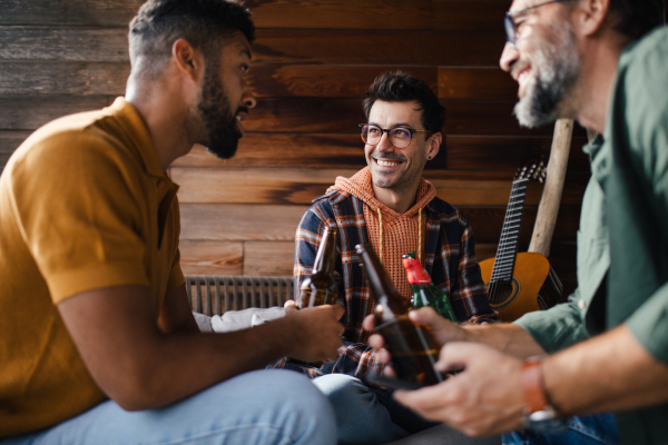 Best friends togehter, drinking beer and talking, having fun and laugh. Concept of male friendship, bromance.