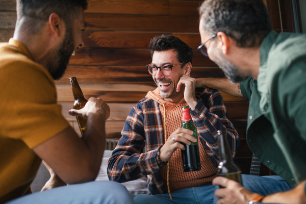 Best friends togehter, drinking beer and talking, having fun and laugh. Concept of male friendship, bromance.