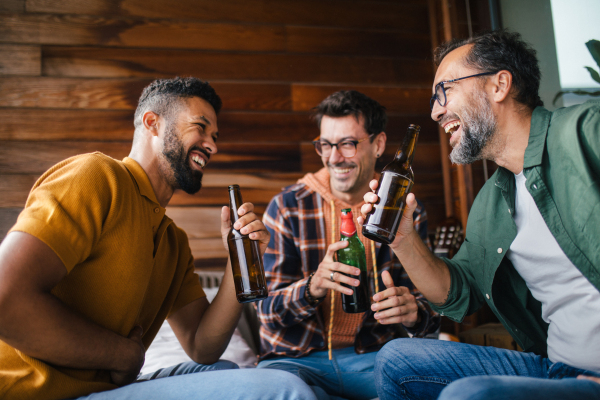 Best friends togehter, drinking beer and talking, having fun and laugh. Concept of male friendship, bromance.