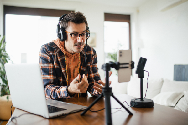 Man as mental health influencer making video for social media. Influencer, doing telepsychology, creating online content about mental health, mental well-being, teaching breath exercises.