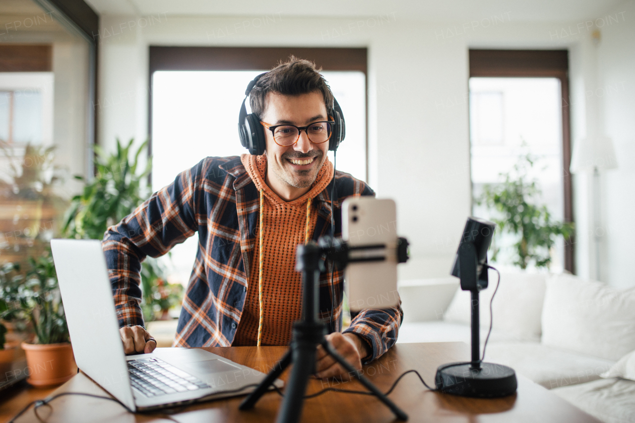 Man as mental health influencer making video for social media. Influencer, doing telepsychology, creating online content about mental health, mental well-being, teaching breath exercises.