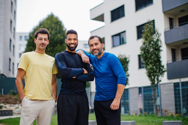 Best friends playing sport outdoors, having fun, competing. Playing basketball at local court, enjoying exercise together. Concept of male friendship, bromance.