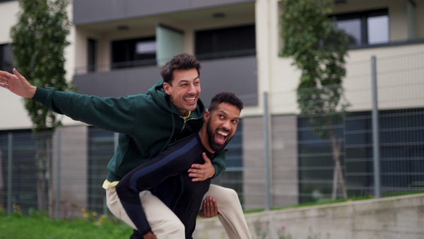 Best friends outdoors, having fun, competing, enjoying exercise together. Concept of male friendship, bromance.