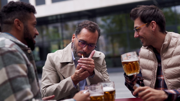 Best friends togehter, drinking beer in bar in the city and talking, having fun and laugh. Concept of male friendship, bromance.