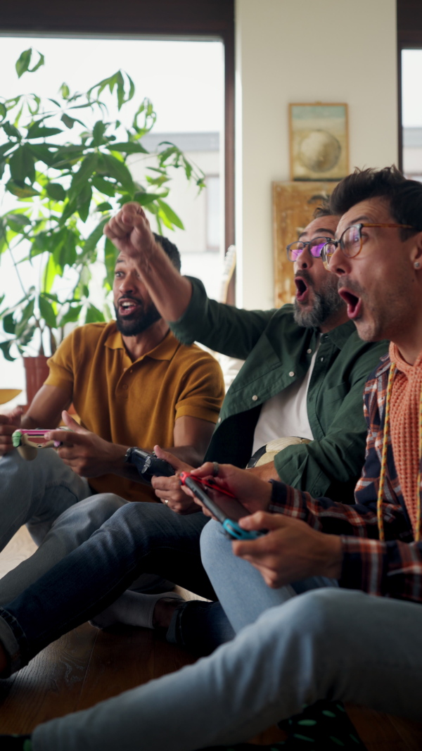 Best friends playing together on video game console, competing. Concept of male friendship, bromance.