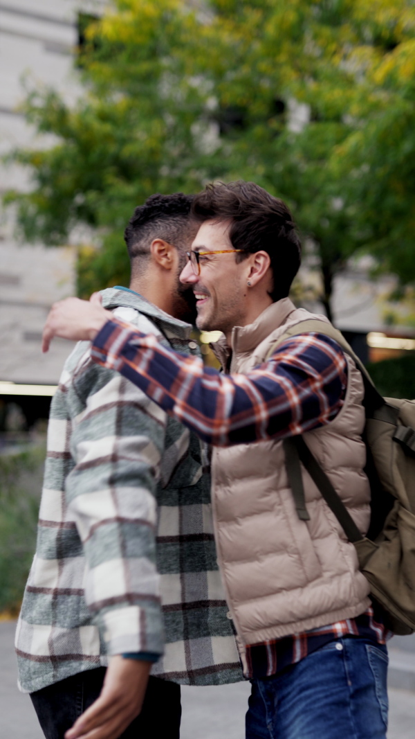 Best friends meeting outdoors, happy to see each other, man's hug. Concept of male friendship, bromance.