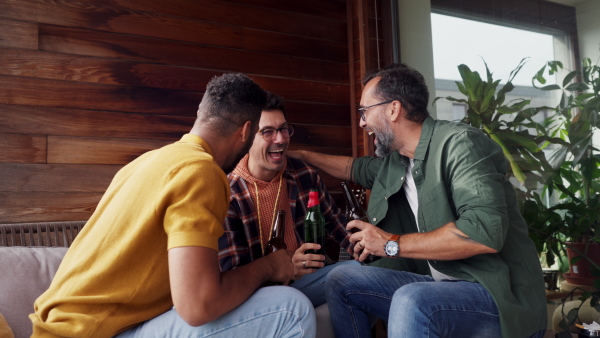 Best friends togehter, drinking beer and talking, having fun and laugh. Concept of male friendship, bromance.