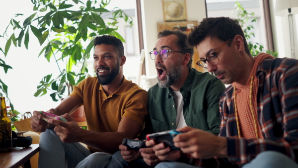 Best friends playing together on video game console, competing. Concept of male friendship, bromance.