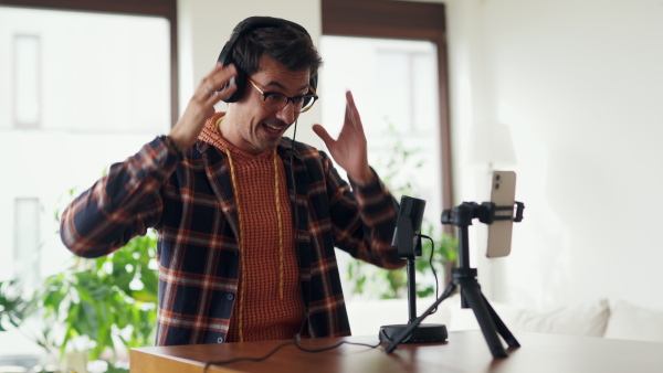 Man as mental health influencer making video for social media. Influencer, doing telepsychology, creating online content about mental health, mental well-being, teaching breath exercises.