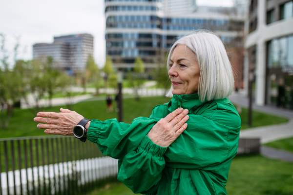 Mature woman stretching before run. Exercising after work for good mental health, physical health, and relieving stress and boost mood.