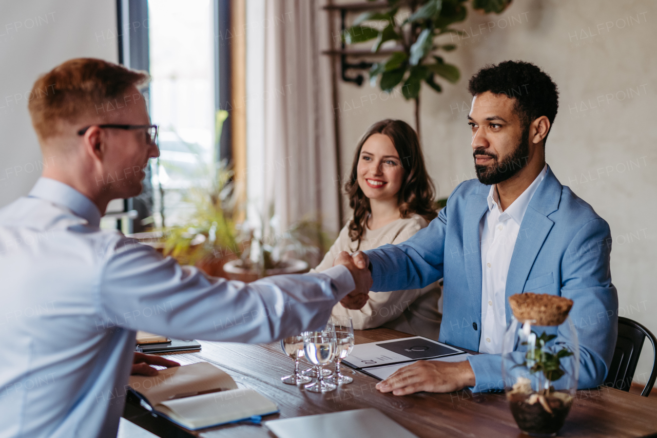 Smiling business partners shaking hands after successful. Closing the business deal. Business communication concept.